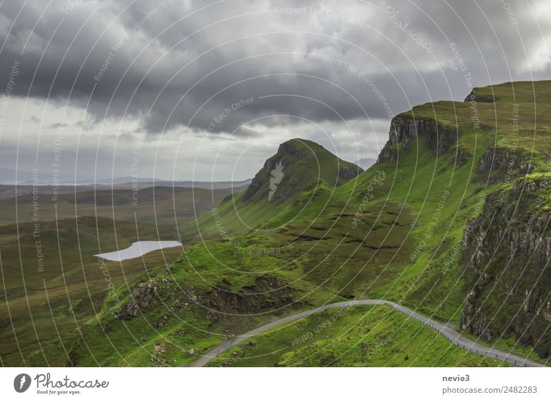 The Quiraing in Scotland Nature Landscape Spring Meadow Hill Mountain Green Isle of Skye Lake Jurassic system Raincloud Steep Country road Street Wiggly line