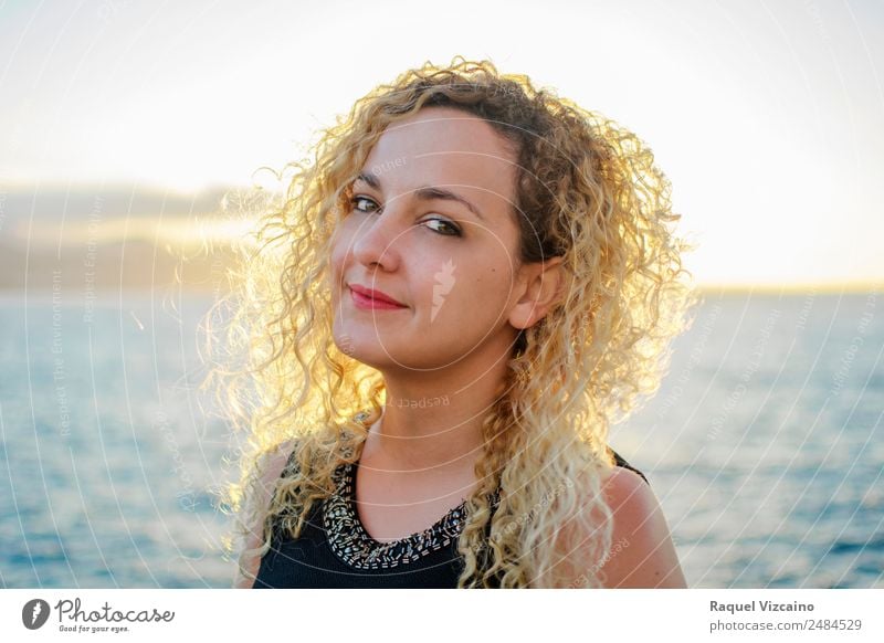 Portrait of blond woman with curly hair backlit by the sun. Feminine Woman Adults 1 Human being 18 - 30 years Youth (Young adults) Landscape Water Sky Horizon