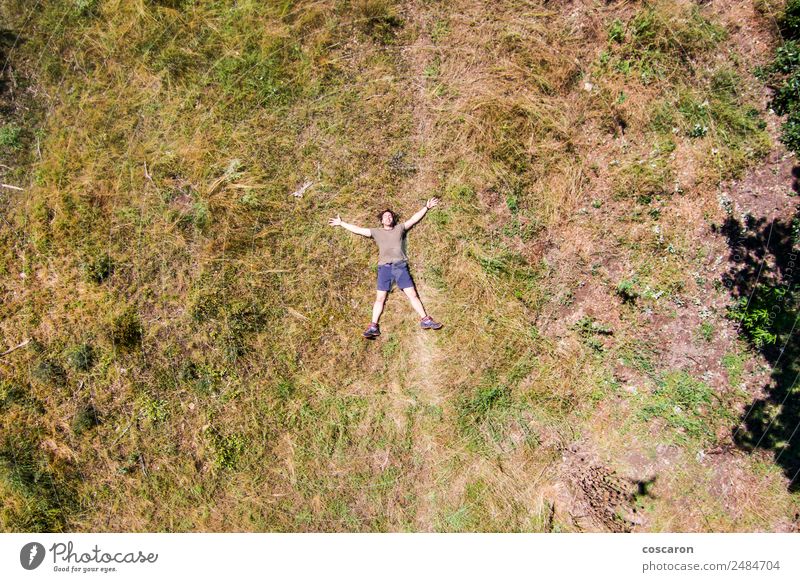 Man lying down on the middle of a field Lifestyle Joy Happy Body Relaxation Leisure and hobbies Freedom Summer Sun Human being Adults Nature Sky Grass Meadow