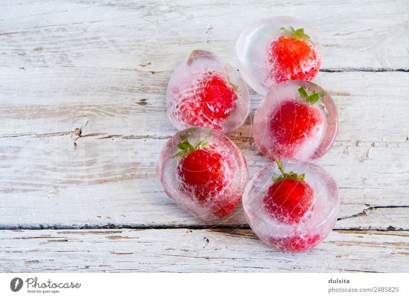 Ice cubes with frozen strawberries Cube Fruit Strawberry Frozen White food Cold Red Summer Background picture Fresh Green healthy water Reflection Berries