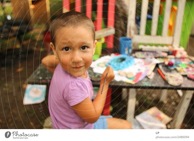 Funny child looking at the camera and painting Lifestyle Leisure and hobbies Playing Children's game Human being Parents Adults Brothers and sisters