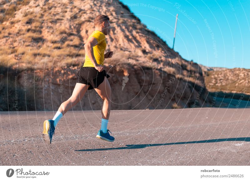 Young man running with greenish yellow shirt Lifestyle Sun Sports Jogging Human being Man Adults Park Bridge Movement Fitness Athletic Speed White young healthy