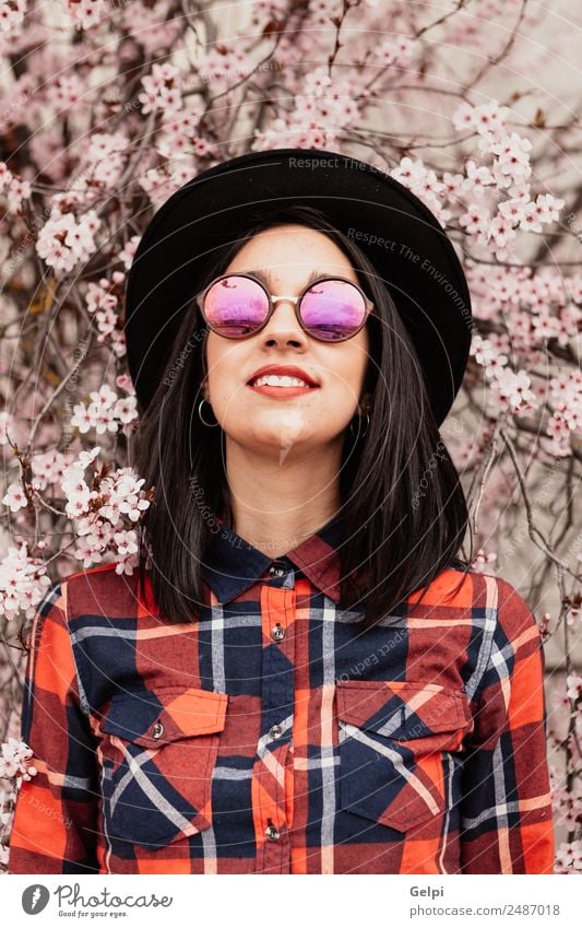 Brunette girl near a almond tree Style Happy Beautiful Face Garden Human being Woman Adults Nature Tree Flower Blossom Park Fashion Sunglasses Hat Smiling