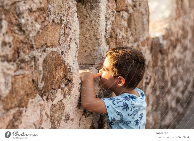 Little boy looking through the wall of a castle Lifestyle Vacation & Travel Tourism Trip Adventure Summer Summer vacation Child Baby Toddler Boy (child) Infancy