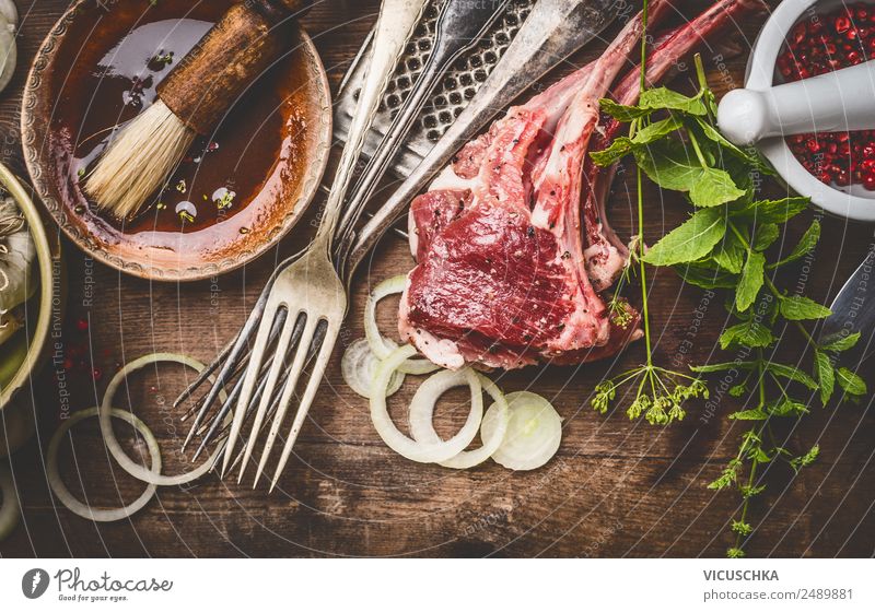 Lamb chops with cooking ingredients Food Meat Herbs and spices Cooking oil Nutrition Dinner Organic produce Crockery Bowl Cutlery Fork Style Design Table