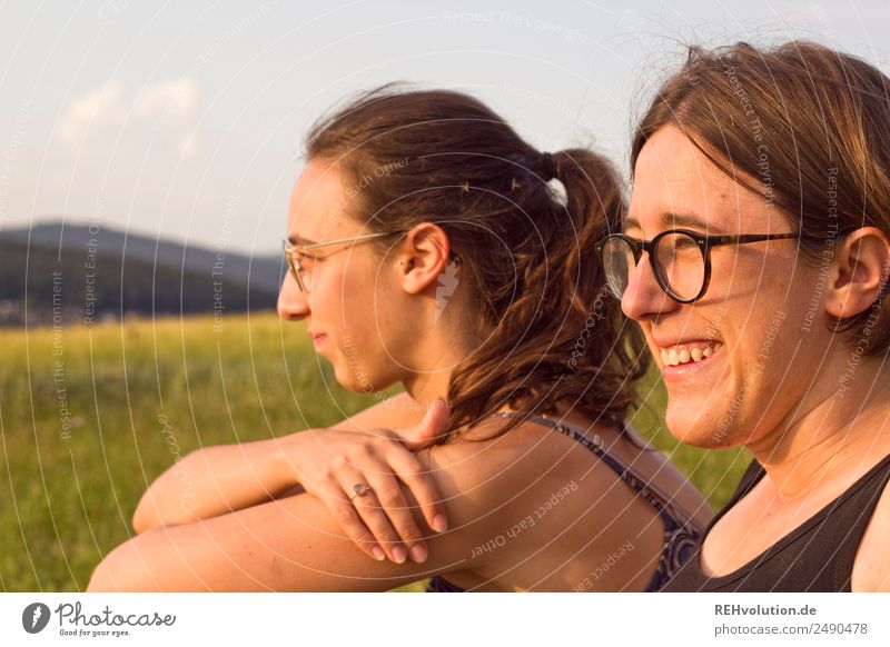 Two young women look into the distance 18 - 30 years 2 Nature Landscape Meadow Sit naturally Contentment Colour photo Exterior shot Free Leisure and hobbies