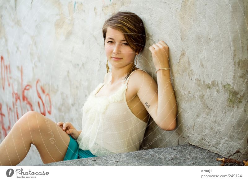 oneself Feminine Young woman Youth (Young adults) 1 Human being 18 - 30 years Adults Wall (barrier) Wall (building) Brunette Short-haired Beautiful Sit Lean
