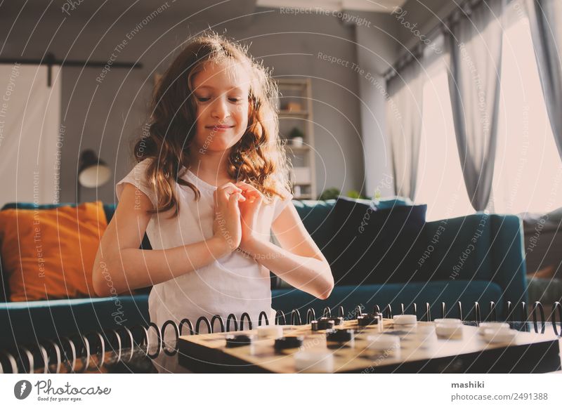lifestyle shot of smart kid girl playing checkers Lifestyle Joy Happy Leisure and hobbies Playing Chess Success Child Parents Adults Family & Relations Infancy