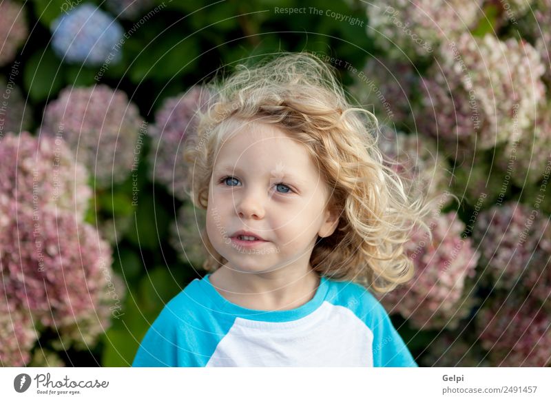 Small child with long blond hair Happy Beautiful Face Summer Garden Child Human being Baby Boy (child) Man Adults Infancy Hand Environment Nature Plant Flower