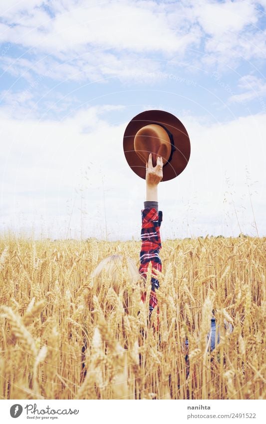 Hand holding a cowboy hat in a field of wheat Grain Wheat Wheatfield Design Joy Freedom Summer vacation Agriculture Forestry Arm Environment Nature Landscape