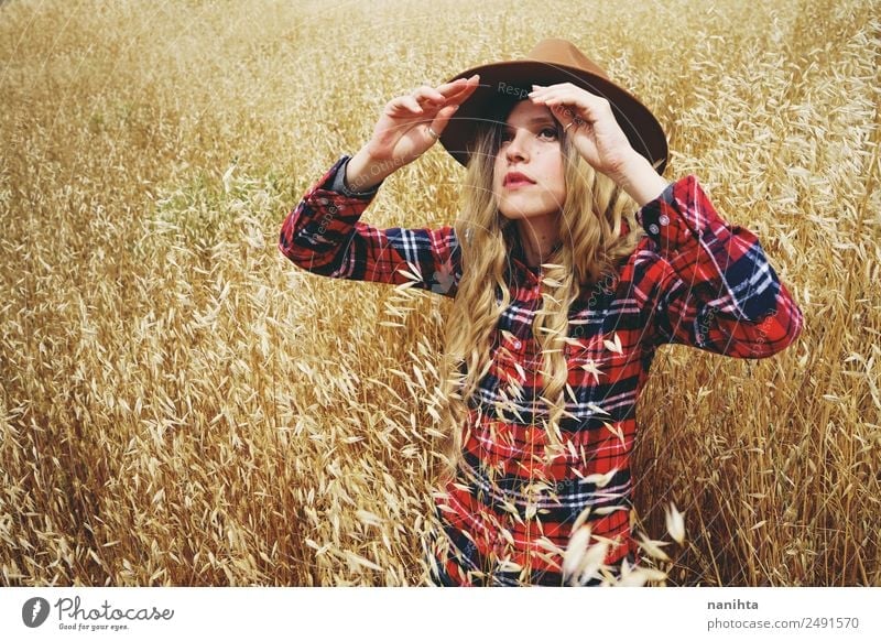 Young woman covering from sun in a wheatfield Grain Lifestyle Style Freedom Summer Summer vacation Sun Human being Feminine Youth (Young adults) 1 18 - 30 years