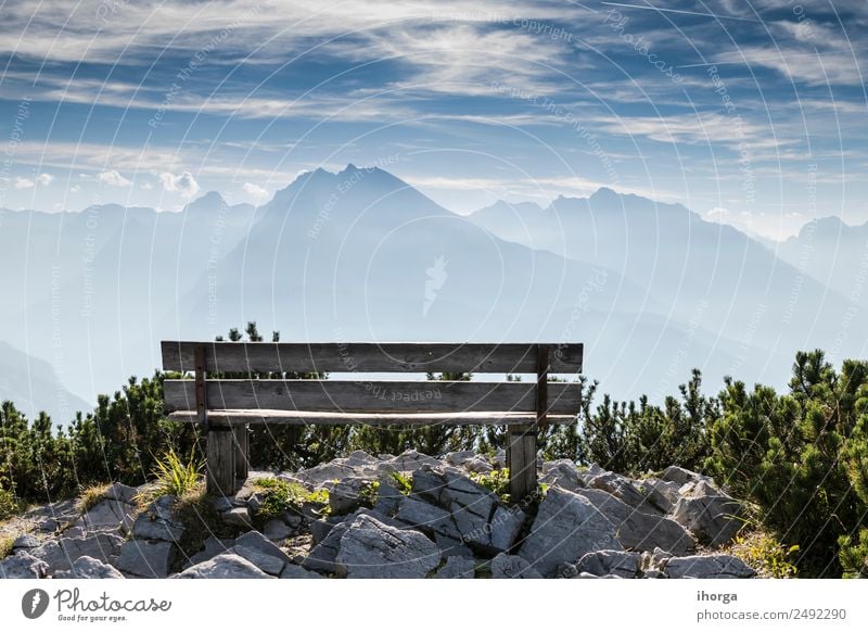 Empty park bench in high mountains Beautiful Relaxation Vacation & Travel Tourism Mountain Hiking Nature Landscape Sky Clouds Grass Park Alps Peak Stone Wood