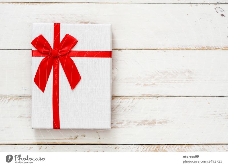 White gift box on white wooden background. Top view. Copyspace Christmas & Advent Packaging Box Decoration Souvenir Ornament Red Gift Carton Vacation & Travel