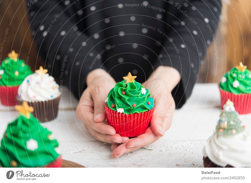 Woman taking with hands christmas cupcake Neutral Background Background picture Baking Blur Bright Baked goods Cake Feasts & Celebrations Christmas & Advent