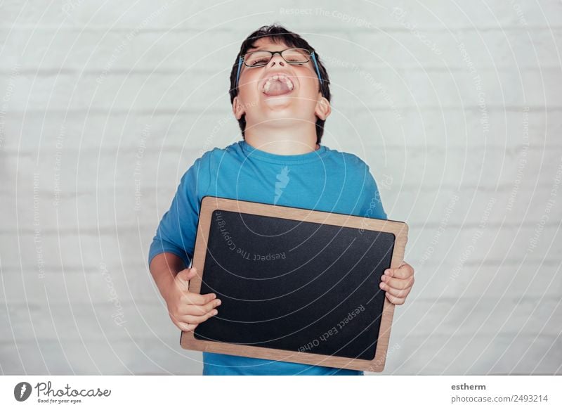 happy child with a blackboard Lifestyle Joy Education Child School Blackboard Boy (child) Infancy 1 Human being 8 - 13 years Movement To hold on Smiling