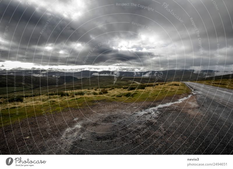 Dark clouds over the Scottish Highlands Landscape Meadow Field Threat Dirty Cold Wet Gloomy Brown Gray Hill Gravel road Gravel path Scotland Europe