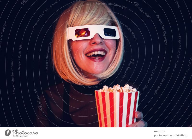 Young blonde woman enjoying a movie in the cinema Food Fast food Popcorn Lifestyle Style Joy Leisure and hobbies Event Going out Human being Feminine Young man