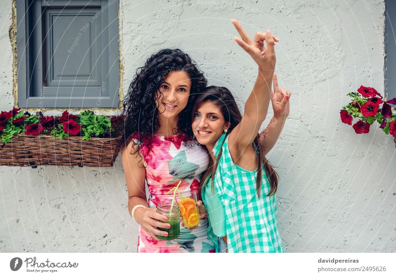 Two women with beverages doing victory sign Vegetable Fruit Beverage Juice Lifestyle Joy Happy Leisure and hobbies Summer Success Human being Woman Adults