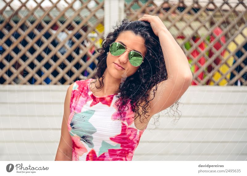 Woman with sunglasses looking at camera over garden fence Lifestyle Joy Happy Beautiful Face Leisure and hobbies Summer Garden Mirror Human being Adults Dress