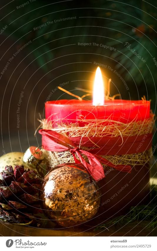Christmas candles on wooden background. Christmas & Advent Candle Red Serene Calm Decoration Ornament Fire Wooden table Feasts & Celebrations Seasons Winter