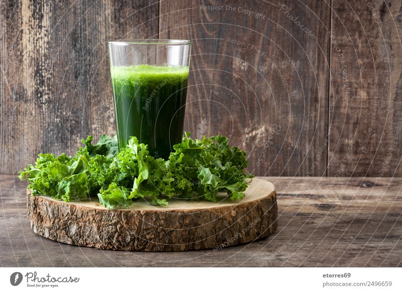 Kale smoothie in glass on wooden background. Milkshake Beverage Drinking Green Detox Healthy Healthy Eating Vitamin superfood Vegan diet Vegetarian diet Diet