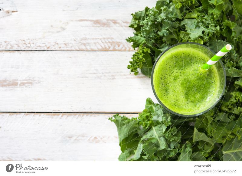 Kale smoothie in glass on white wooden background. Milkshake Beverage Drinking Green Detox Healthy Healthy Eating Vitamin superfood Vegan diet Vegetarian diet