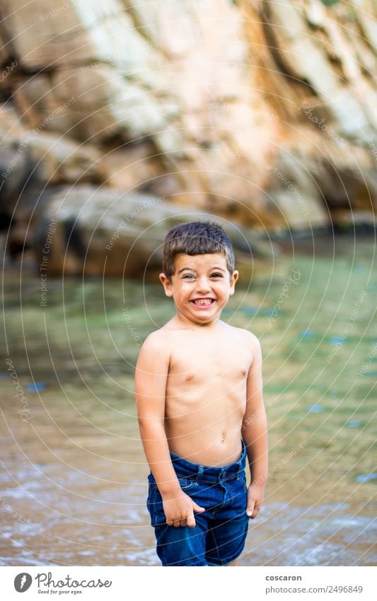 Cute little boy toaching the water with his feet. Lifestyle Joy Beautiful Leisure and hobbies Playing Vacation & Travel Summer Summer vacation Beach Ocean Child
