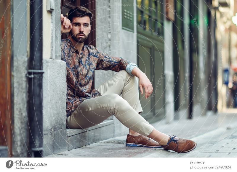 Young bearded man sitting in an urban step Lifestyle Style Beautiful Hair and hairstyles Human being Masculine Young man Youth (Young adults) Man Adults 1