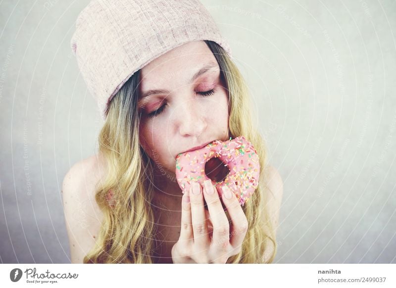 Young woman eating a pink donut Food Candy Donut Eating Fast food Lifestyle Style Design Joy Beautiful Hair and hairstyles Human being Feminine