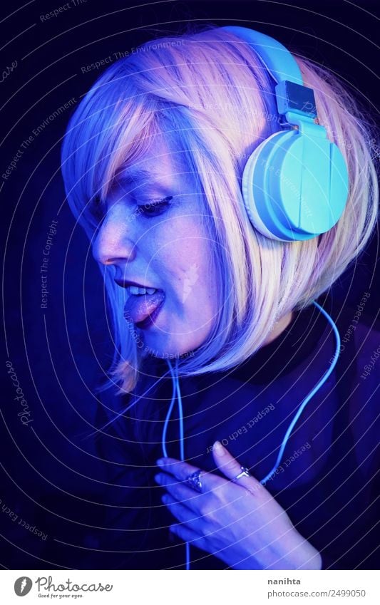 Young woman listening to music Lifestyle Style Design Exotic Joy Night life Entertainment Party Event Music Disc jockey Headset Headphones Technology