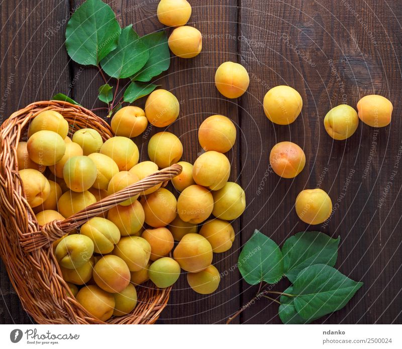 ripe yellow apricots Fruit Nutrition Vegetarian diet Diet Table Nature Leaf Wood Fresh Delicious Natural Juicy Brown Yellow Colour Basket agriculture Apricot