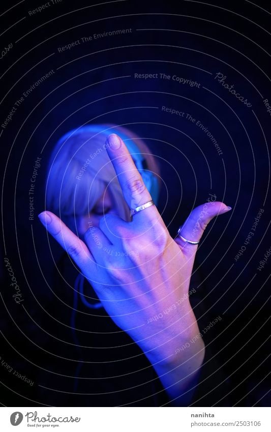 Woman making a rock sign with her hand Lifestyle Style Design Technology Entertainment electronics Human being Feminine Young woman Youth (Young adults) Adults