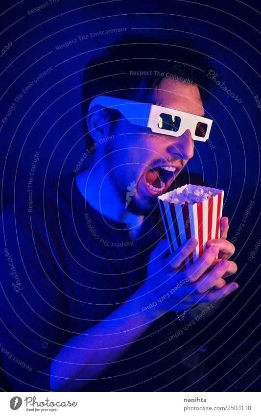 Young crazy man watching a movie Food Popcorn Lifestyle Style Leisure and hobbies Entertainment Going out Human being Masculine Man Adults 1 30 - 45 years