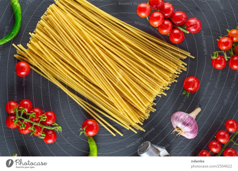 Uncooked pasta spaghetti Vegetable Dough Baked goods Herbs and spices Lunch Eating Fresh Large Long Above Yellow Red Black Colour Tradition Spaghetti food