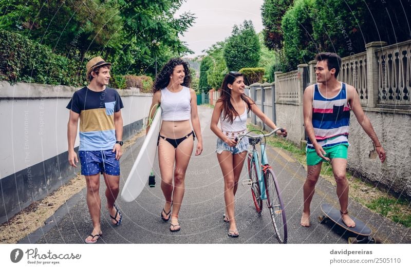 Happy young people walking along road in summer day Lifestyle Joy Relaxation Leisure and hobbies Vacation & Travel Summer Sports Woman Adults Man Friendship