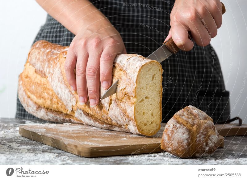 Woman cutting bread on wooden table Food Healthy Eating Food photograph Bread Breakfast Feminine Adults 1 Human being 30 - 45 years Work and employment Fresh