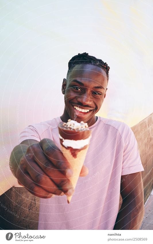 Young black man holding an ice cream Food Ice cream Nutrition Eating Lifestyle Style Wellness Summer Summer vacation Human being Masculine Young man