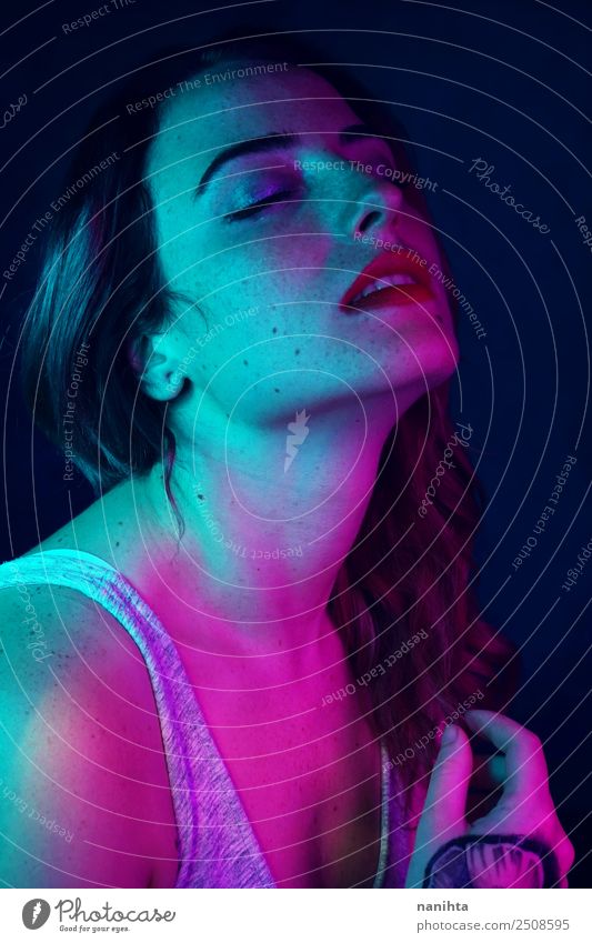 Beautiful young woman illuminated by colored lights Elegant Style Design Skin Face Freckles Harmonious Senses Human being Feminine Young woman
