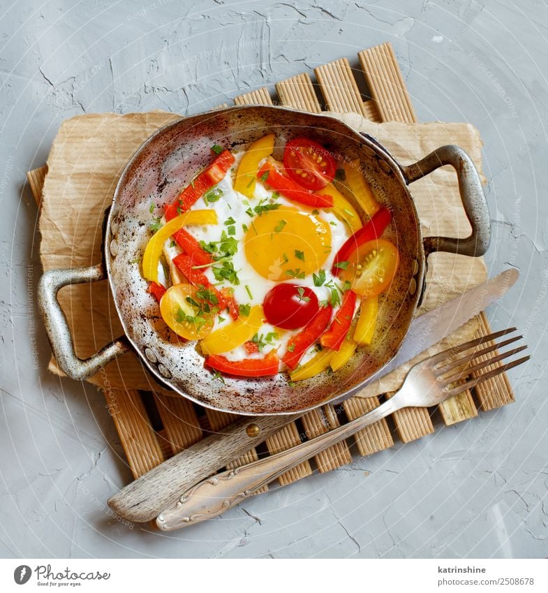 Fried egg with a bell pepper and tomatoes Vegetable Breakfast Pan Fork Table Fresh Bright Yellow Gray Red Cholesterol Cooking fat food Frying