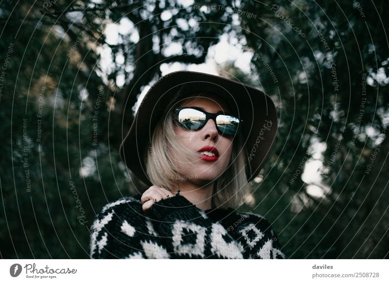 Portrait of blonde woman with sunglasses and a hat with the forest reflected on the glasses Lifestyle Elegant Style Vacation & Travel Trip Adventure Human being