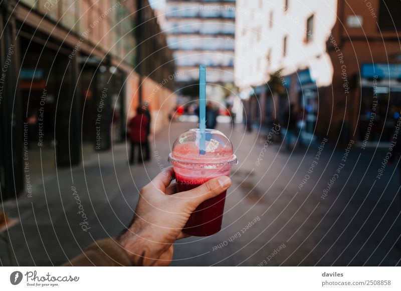 Hand holding a purple smoothie in the street Vegetable Fruit Breakfast Diet Beverage Juice Lifestyle Shopping Healthy Eating Wellness Human being Man Adults 1
