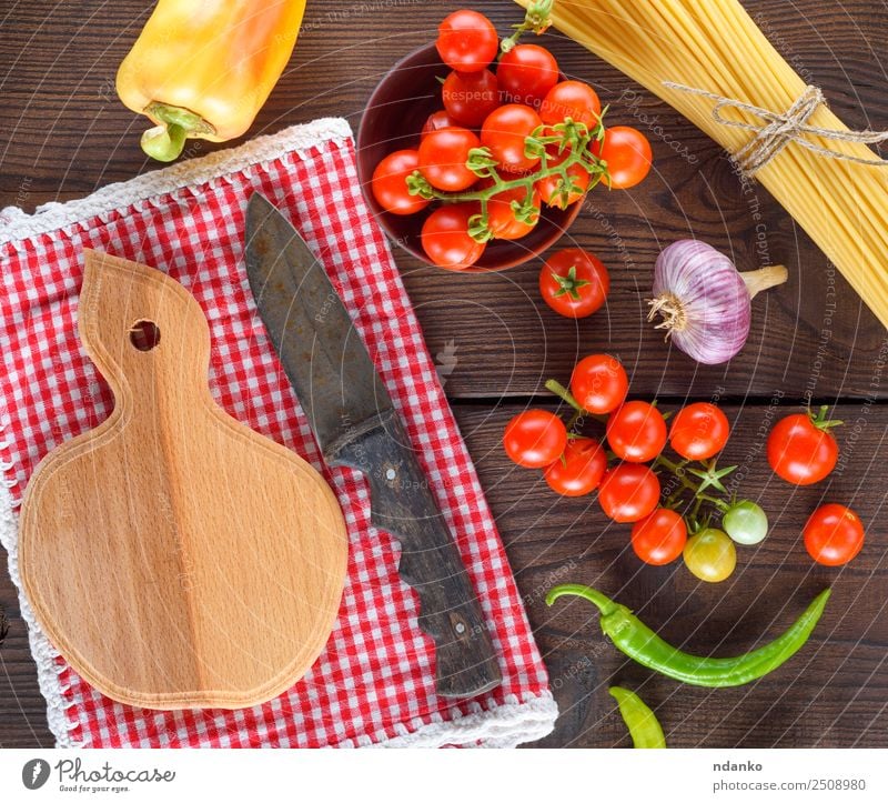 cutting board with a knife Vegetable Dough Baked goods Knives Wood Fresh Large Long Above Brown Yellow Red Black Colour Tradition Spaghetti pasta food Tomato