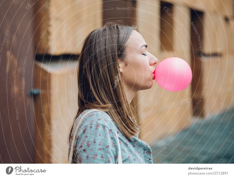 Young teenage girl blowing pink bubble gum Lifestyle Joy Happy Beautiful Face Human being Woman Adults Youth (Young adults) Mouth Lips Fashion Brunette Balloon