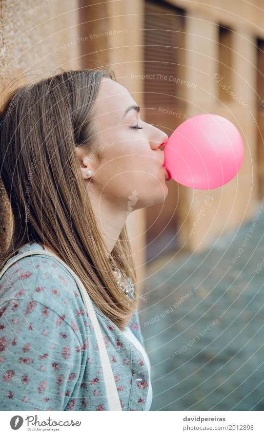 Young teenage girl blowing pink bubble gum Lifestyle Joy Happy Beautiful Face Calm Human being Woman Adults Youth (Young adults) Mouth Lips Brunette Balloon