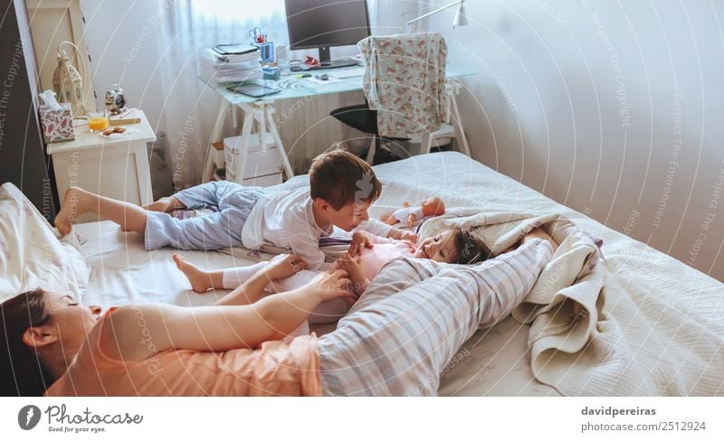 Happy family playing over the bed in a relaxed morning. Weekend family leisure time concept. Lifestyle Joy Beautiful Relaxation Leisure and hobbies Playing