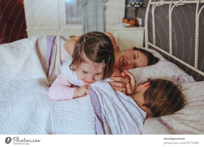 Little girl playing over boy lying in the bed Lifestyle Joy Happy Beautiful Relaxation Leisure and hobbies Playing Bedroom Child Baby Boy (child) Woman Adults