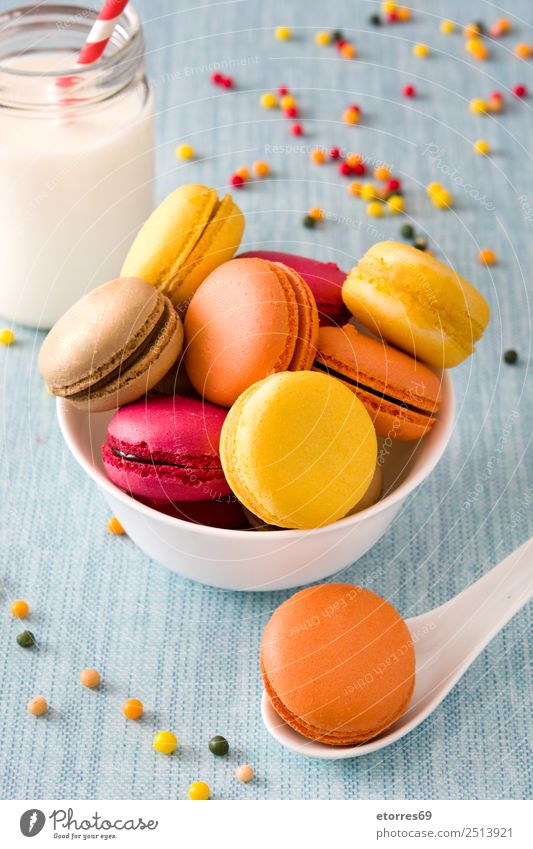 Milk and colored macaroons on blue background Macaron Sweet Candy Food Healthy Eating Food photograph Dessert french Delicious Snack Cookie Tradition Pink Wood