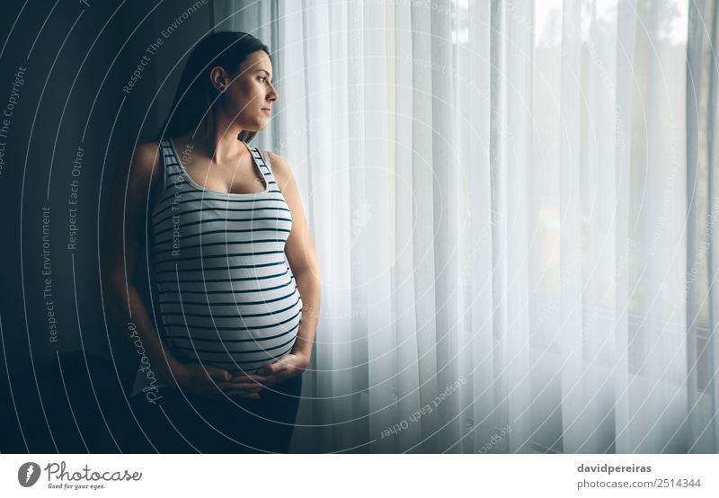 Pregnant woman holding her belly Lifestyle Beautiful Calm Parenting Human being Baby Woman Adults Parents Mother Hand Think Love Wait Authentic Serene