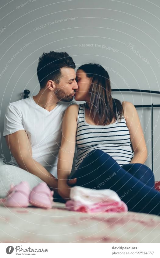 Man kissing his pregnant wife Beautiful Human being Baby Woman Adults Mother Family & Relations Couple Clothing Footwear Beard Kissing Love Sit Embrace