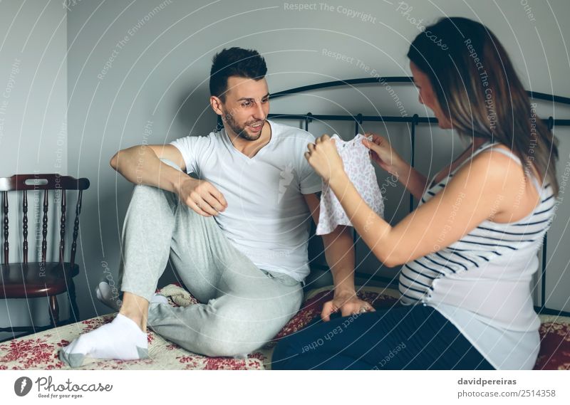 Pregnant showing dress to her husband Happy Beautiful Chair Bedroom Human being Baby Woman Adults Man Mother Father Family & Relations Couple Partner Clothing